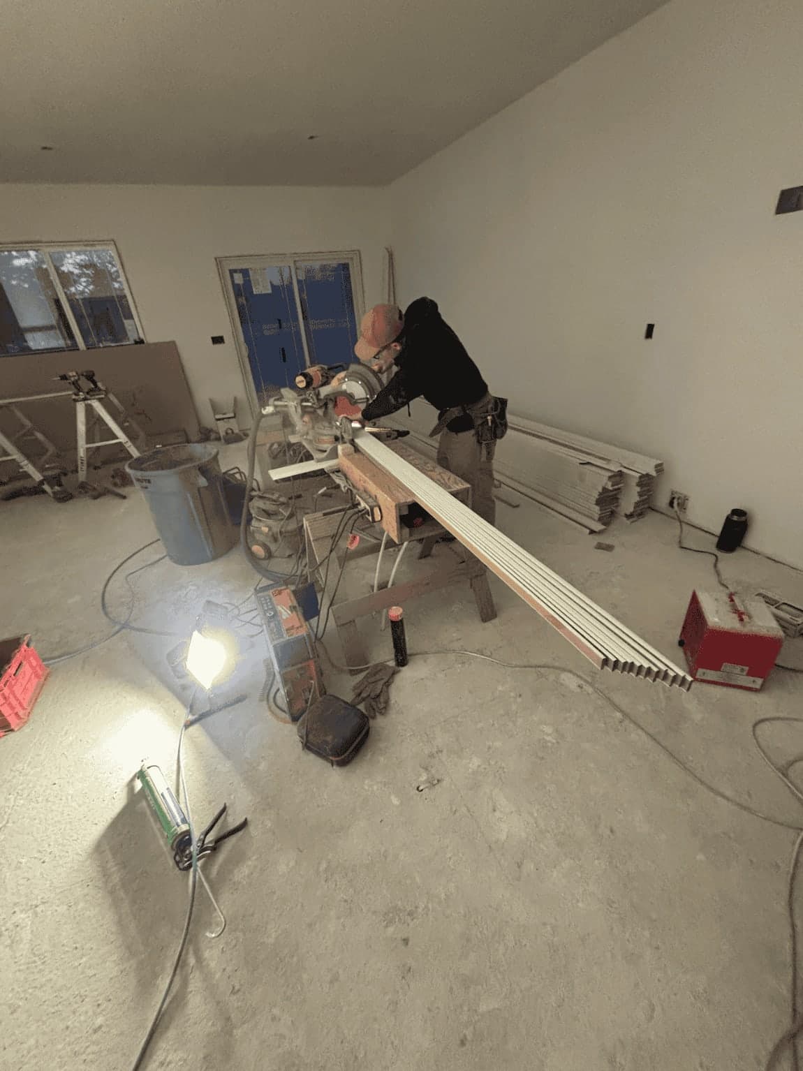 HODA Construction craftsman cutting trim with precision